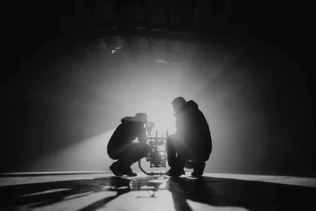 camera operator and director working together